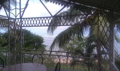 a patio with a table and a palm tree at Ideal for kite surfer&family in Le Morne