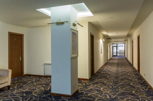 a corridor of a hotel room with a white column at Armenia Hotel in Jermuk