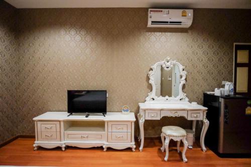 a white dressing table with a mirror and a chair at The O-Zone Airport Inn in Lat Krabang