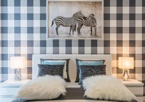 a bedroom with two zebras on the wall at Apartment Dąbrowskiego by The Railway Station Wroclaw in Wrocław