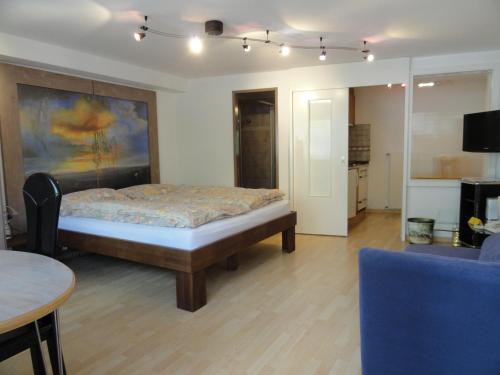 a bedroom with a bed and a table and a couch at Artist Apartments & Hotel Garni in Zermatt