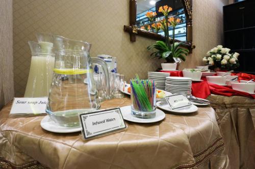 a table with a jug of liquid on a table at Coins Hotel Jakarta in Jakarta
