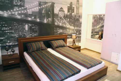 a bedroom with a bed with a city skyline mural at Apartment Sarajevo Center in Sarajevo