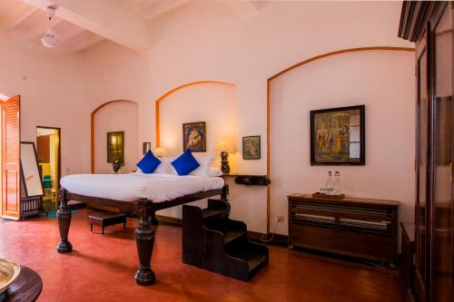 a bedroom with a bed and a dresser in it at Dune de L'orient in Puducherry