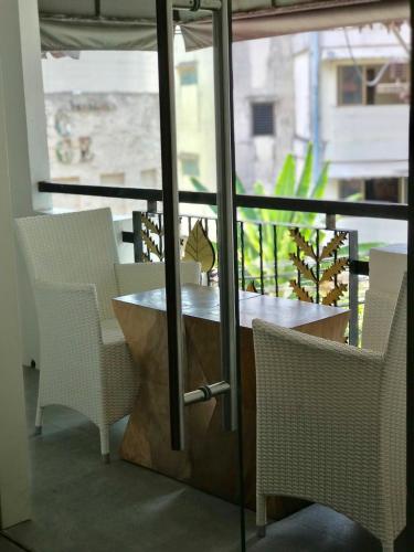 a table and chairs in a room with a window at Baipho Lifestyle in Patong Beach