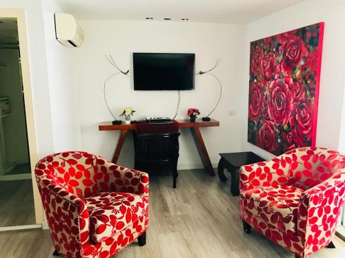 a living room with two chairs and a tv at Baipho Lifestyle in Patong Beach