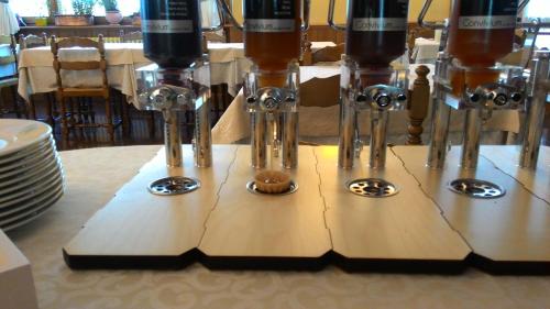 a row of wine glasses sitting on top of a table at Hotel Migliorati in Castione della Presolana