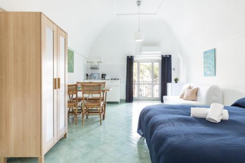 a living room with two beds and a dining room at La rosa dei venti in Gaeta