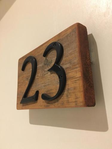 a wooden plaque with the number on a wall at The Tower Arms Hotel in Iver