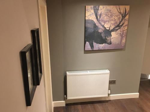 a living room with a radiator and a painting at The Tower Arms Hotel in Iver