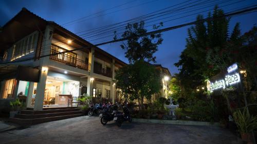 a group of motorcycles parked outside of a building at night at Buathong Place in Lamai