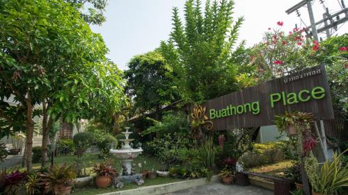 a sign for a garden place with trees and plants at Buathong Place in Lamai