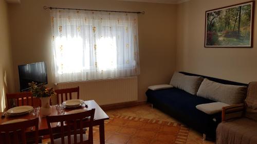 a living room with a couch and a table at Laci Apartman in Zalakaros
