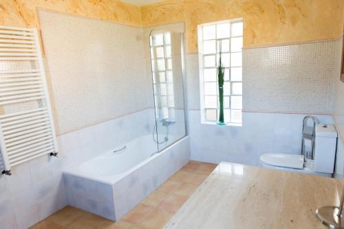 a bathroom with a tub and a sink and a toilet at Cal Tio Lluc in Sóller