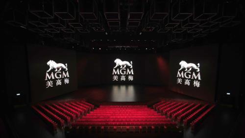 a stage with red chairs and two horses on signs at MGM Cotai in Macau