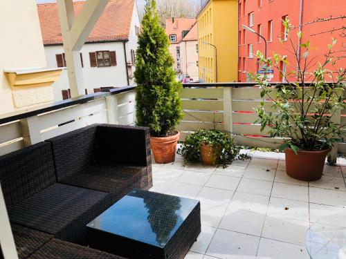 a balcony with a bench and potted plants on it at Hotel Mariahilf München in Munich