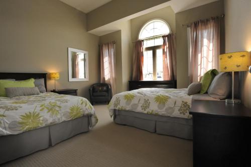 A bed or beds in a room at Boardwalk Homes Executive Guest Houses