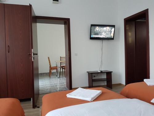 a hotel room with two beds and a table at Pension Yasmine in Timişoara