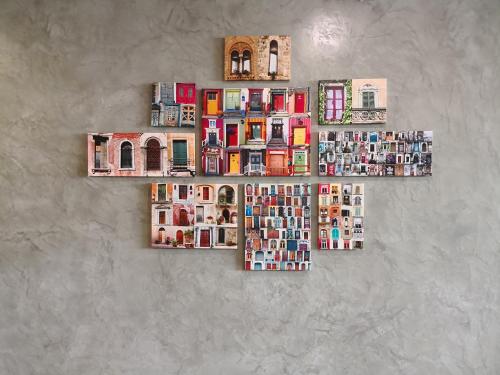 a collage of photos of buildings on a wall at Bloommaze Boutique Hotel Puchong in Puchong