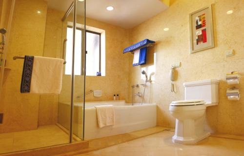 a bathroom with a shower and a toilet and a sink at Broadway Mansions Hotel - Bund in Shanghai