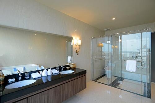 a bathroom with two sinks and a shower at Aria Centra Surabaya in Surabaya