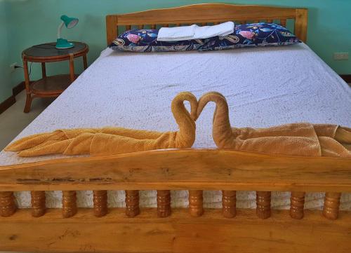two swans are carved into a bed at Sofias House Rental in Tagbilaran City