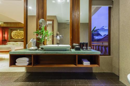 a bathroom with a sink and a large mirror at Golden Temple Boutique in Siem Reap