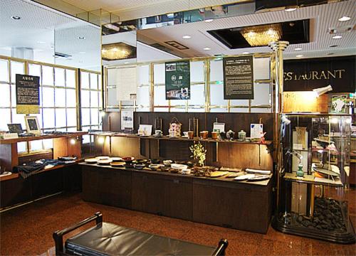 a fast food restaurant with a counter and a counter at Kurume Station Hotel in Kurume