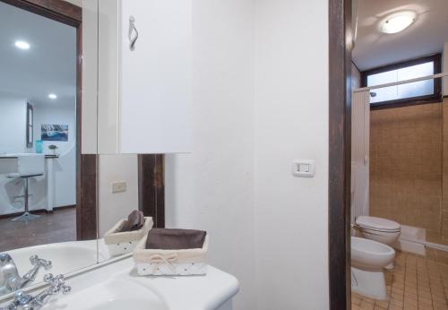 a bathroom with a tub and a toilet and a sink at Residenze al Castello Apartments in Cagliari
