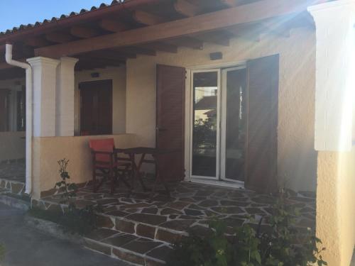 a patio with a table and a sliding glass door at Villa Panorea in Moraitika