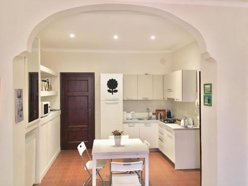 a kitchen with a table and chairs and a table and a table at Casa Francesca in Lucca
