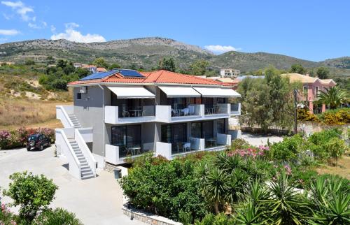 an image of a house with mountains in the background at Paspalis Hotel in Skala Kefalonias