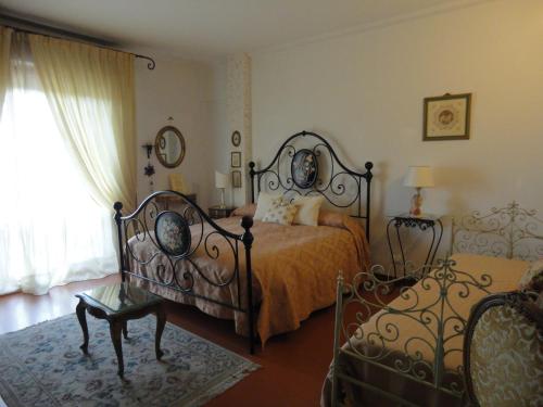 a bedroom with two beds and a window at Cisanello House in Pisa