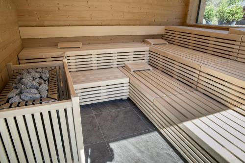a sauna with wooden shelves and a window at Hotel Gran Paradiso in San Cassiano
