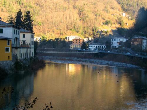vista su un fiume con case e edifici di tuscanrooms apartment a Lucca