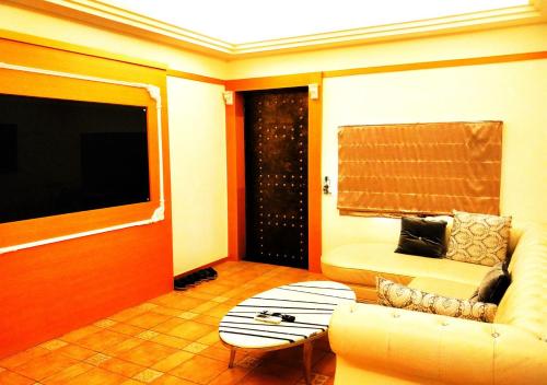 a living room with a couch and a table at Borabora B&B in Nanwan