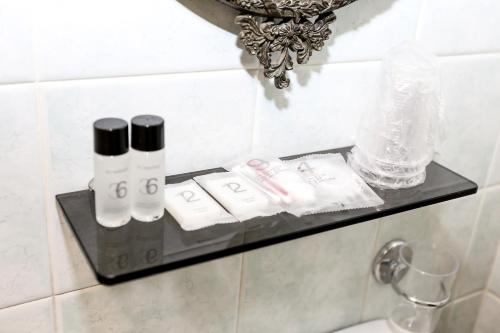 a shelf in a bathroom with some items on it at Hotel Mignon in Padova