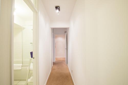 a hallway with a door leading to a room at Comfy 2BR Flat with Wi-Fi in Bishop's Stortford in Bishops Stortford