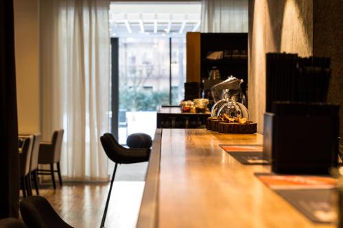 a long wooden table in a room with chairs at Hotel Shuum Boutique - Destigo Hotels in Kołobrzeg