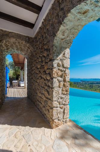an external view of a villa with a pool at Villa Bournella in Ýpsos