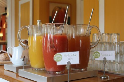 a group of three glasses of juice on a counter at Tofta Herrgård in Lycke