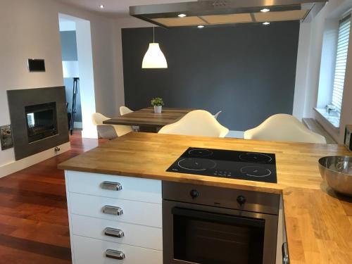 a kitchen with a stove and a table with chairs at Amelia in Schodnia Stara
