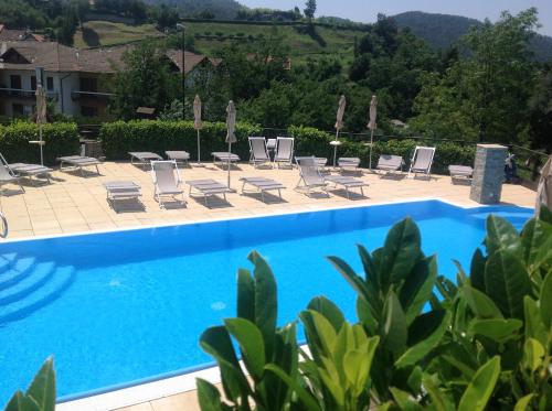 a swimming pool with lounge chairs and a resort at Hotel Pian del Sole in Sassello