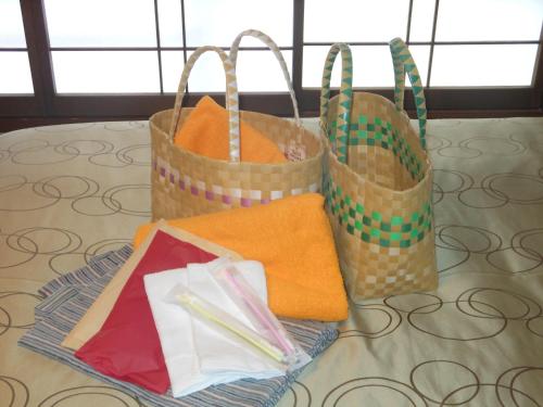 three paper bags sitting on top of a table at Onyado Tsutaya in Kiso