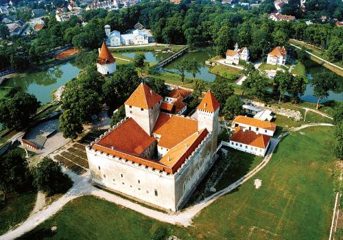 an aerial view of a large castle with a lake at Cozy Summer House with Free Parking near City Center & Beach in Kuressaare