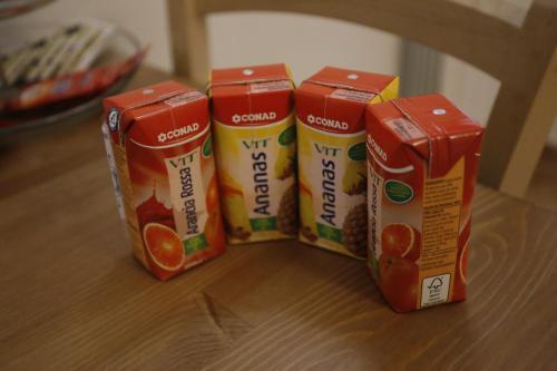 three cans of orange juice sitting on a table at Agriturismo Villalta in Ponte Felcino