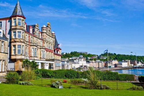 a large building with a tower on the side of a river at Muthu Alexandra Hotel in Oban