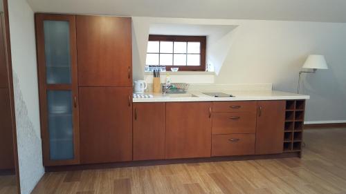 Una cocina con gabinetes de madera y encimera. en Apartment 41 Miodowy Pod Aniołem, en Kazimierz Dolny