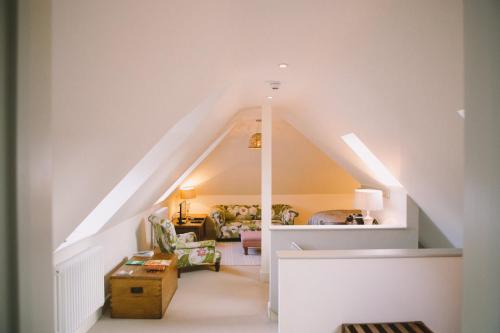 a living room with a staircase in a house at The Hero in Burnham Market