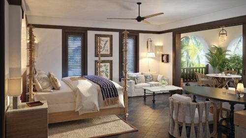 a bedroom with a bed and a living room at Cap Juluca, A Belmond Hotel, Anguilla in West End Village